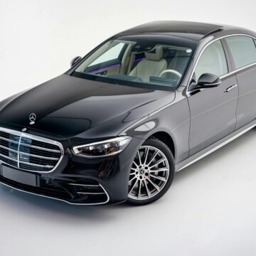 Elegant black Mercedes-Benz S Class car in a modern studio setting.